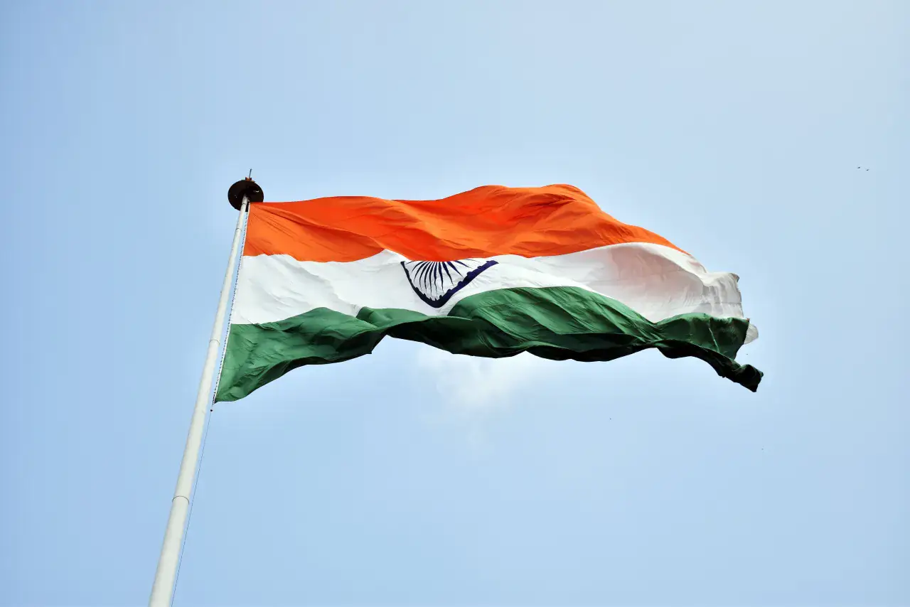 The Indian national flag flying against a clear sky