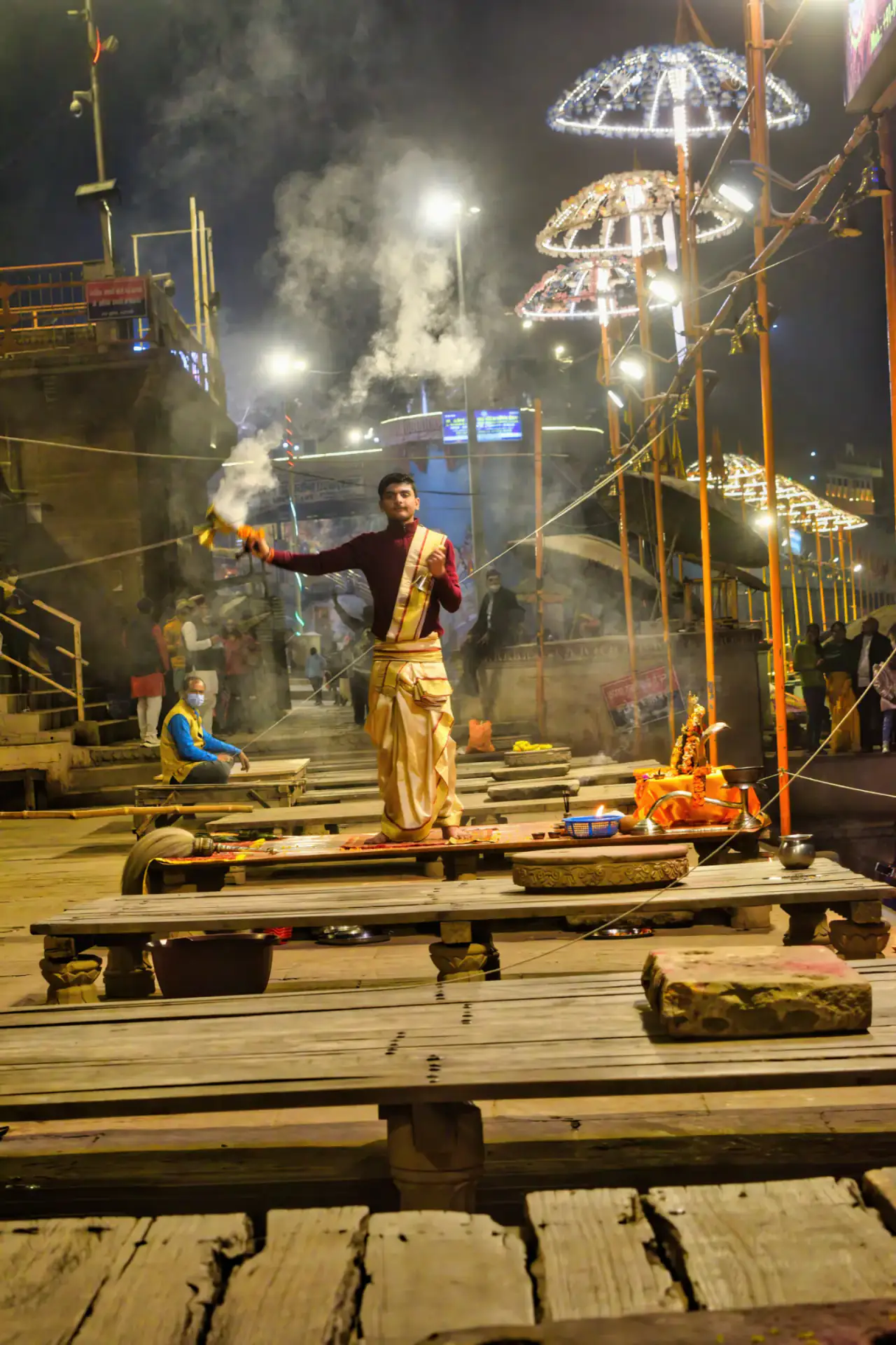 A priest raises a multi-tiered lamp during Ganga Aarti in Varanasi
