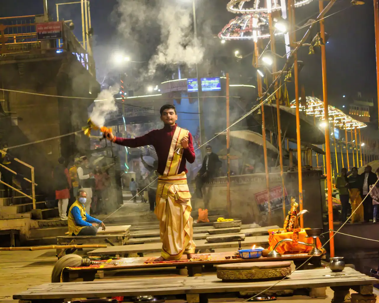 A priest raises a multi-tiered lamp during Ganga Aarti in Varanasi