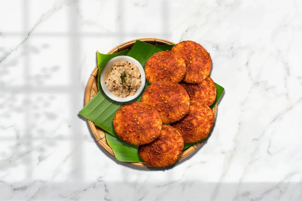 Adai served with sambar and coconut chutney on a banana leaf